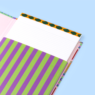 A4 lined notepad with patterned header on blue background