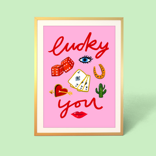 Eleanor Bowmer artwork with 'Lucky You' text and luck symbols on a pink background