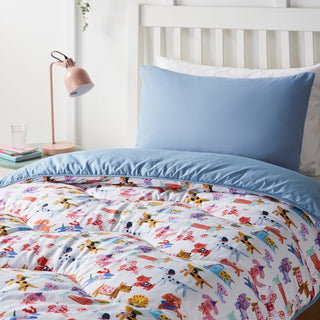 Kid's bed with colourful bedding and a blue pillow, lamp on nightstand, framed pictures on shelf.