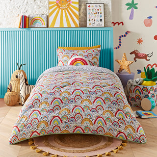 Children's bedroom with a bed featuring a rainbow-patterned duvet, colourful wall art, and toys.