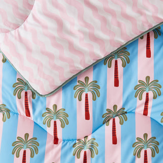 Reversible duvet with palm tree pattern on a blue background