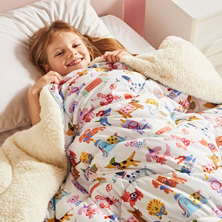 Child lying in bed under a colourful quilt with animal patterns in a cosy bedroom setting.